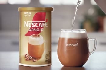 Nescafé cappuccino packaging beside a prepared coffee